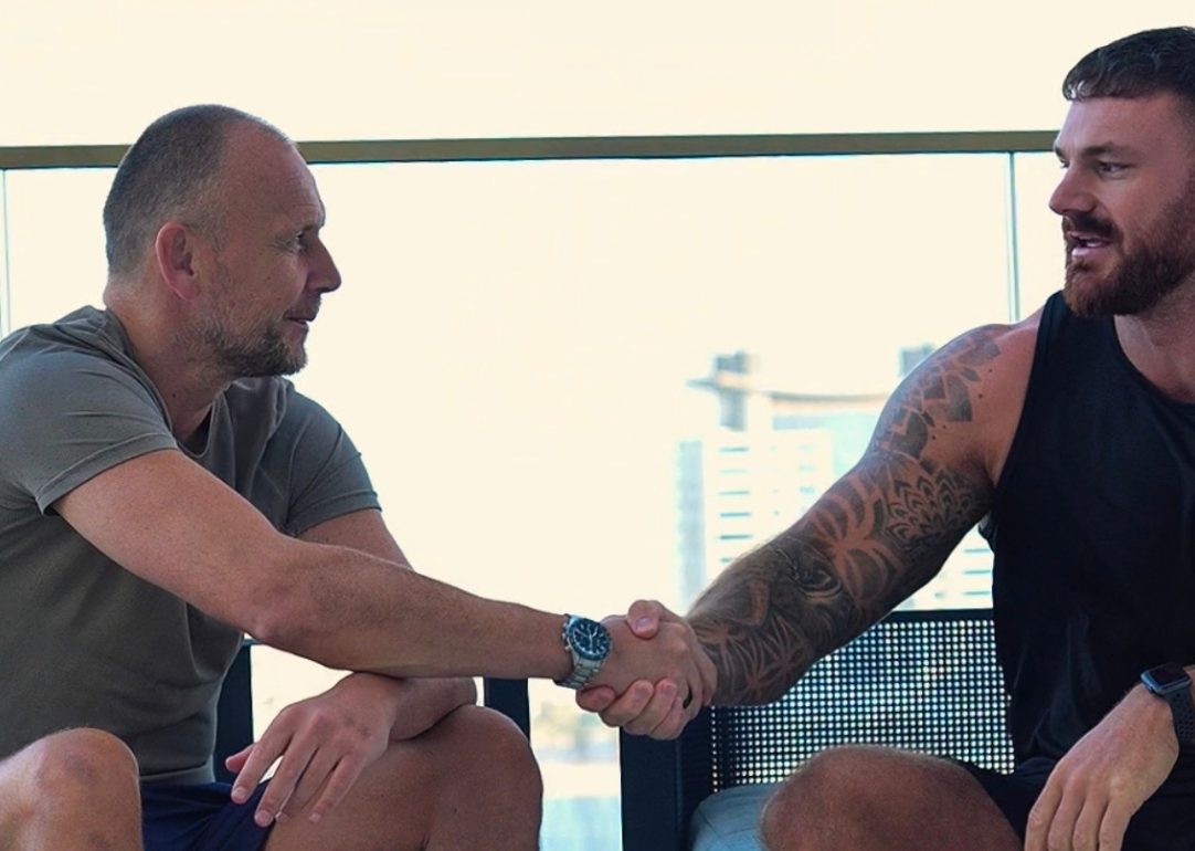 Personal trainer Tommy Mitchell with a client on a rooftop in Dubai